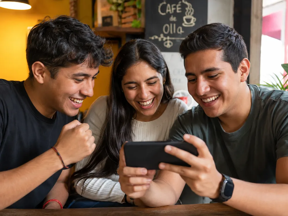 Mexican players checking Fortune Gems casino game on mobile phone